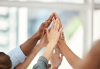 Hands reaching up for a group high five
